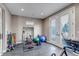 Home gym with exercise equipment, mirrored wall, recessed lighting, and French doors at 15902 W 64Th Ave, Arvada, CO 80007