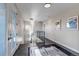 Hallway featuring tile floors, modern lighting, and neutral paint at 15902 W 64Th Ave, Arvada, CO 80007