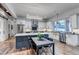 Modern kitchen with large island, stainless steel appliances, and eat-in dining area at 15902 W 64Th Ave, Arvada, CO 80007