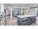 Stylish kitchen island with seating, open to the living room, offering a seamless flow for entertaining at 15902 W 64Th Ave, Arvada, CO 80007
