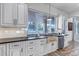 Kitchen featuring a unique sink, stainless steel appliances, and views from a large window at 15902 W 64Th Ave, Arvada, CO 80007