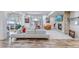 Spacious living room with modern furnishings, fireplace, and large windows offering natural light at 15902 W 64Th Ave, Arvada, CO 80007