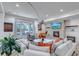 Bright living room with large windows, stone fireplace, and stylish decor, perfect for relaxation at 15902 W 64Th Ave, Arvada, CO 80007