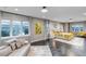 Spacious main bedroom featuring tile floors, sitting area, ensuite bathroom, and expansive windows with views at 15902 W 64Th Ave, Arvada, CO 80007