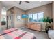 Cozy bedroom with large window, dresser, and views of the outdoor scenery at 15902 W 64Th Ave, Arvada, CO 80007