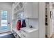 Functional mudroom area featuring built-in storage, bench, and easy access to the outdoors at 15902 W 64Th Ave, Arvada, CO 80007