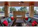 Outdoor living space featuring stone fireplace and comfortable seating area with views of the pool at 15902 W 64Th Ave, Arvada, CO 80007