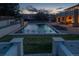 Backyard pool with fountains surrounded by a patio, grass area, and privacy walls for a relaxing outdoor space at 15902 W 64Th Ave, Arvada, CO 80007