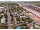 Aerial view showcases a charming neighborhood near green spaces, highways, and the Denver city skyline in the background at 2258 S Galapago St, Denver, CO 80223