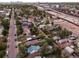 Aerial view showcases a charming neighborhood near green spaces, highways, and the Denver city skyline in the background at 2258 S Galapago St, Denver, CO 80223