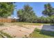 Large backyard with a concrete patio and mature trees, perfect for outdoor entertaining at 2258 S Galapago St, Denver, CO 80223