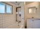 Bathroom featuring a shower, a window, and a modern vanity at 2258 S Galapago St, Denver, CO 80223