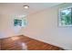 Bedroom showcasing hardwood floors and two bright windows at 2258 S Galapago St, Denver, CO 80223