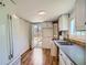 Kitchen with white cabinets, appliances, and access to the backyard at 2258 S Galapago St, Denver, CO 80223