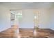 Bright living room with hardwood floors leading to the kitchen and bathroom at 2258 S Galapago St, Denver, CO 80223