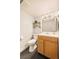 Bright bathroom features a wood vanity, decorative shelving, and modern fixtures at 1150 Inca St # 39, Denver, CO 80204