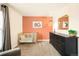 Bedroom features wood crib, black dresser and decor shelf at 1150 Inca St # 39, Denver, CO 80204