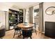 Dining area boasts a wood table, classic chairs, and views of the outdoors through large windows at 1150 Inca St # 39, Denver, CO 80204