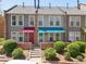 Charming townhomes boast colorful awnings, brick accents, and well-manicured landscaping at 1150 Inca St # 39, Denver, CO 80204