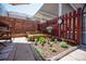 The property features a charming fenced patio with a garden, a clock and colorful blooms at 1150 Inca St # 39, Denver, CO 80204