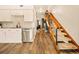 Interior view features hardwood floors, staircase, and seamless flow between kitchen and living area at 1150 Inca St # 39, Denver, CO 80204