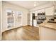 Updated kitchen with stainless steel appliances, bright cabinets and natural light from French doors at 1150 Inca St # 39, Denver, CO 80204
