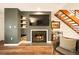 Cozy living room featuring a fireplace, built-in shelves, and wood flooring at 1150 Inca St # 39, Denver, CO 80204