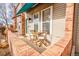 The inviting patio features a cozy seating area, framed by brick and a colorful awning at 1150 Inca St # 39, Denver, CO 80204