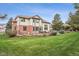 Large back yard with patio, outdoor seating, landscaped yard, and partial home exterior at 14417 W 57Th Pl, Arvada, CO 80002
