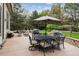 Expansive backyard featuring a patio with a dining table, chairs, and lush greenery for outdoor enjoyment at 14417 W 57Th Pl, Arvada, CO 80002