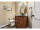 Stylish powder room with custom oval mirror, granite counters, and beautiful fixtures, with modern toilet at 14417 W 57Th Pl, Arvada, CO 80002