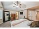 A well-lit bedroom with a view of the en-suite bathroom and walk-in closet at 14417 W 57Th Pl, Arvada, CO 80002