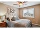 Serene bedroom with decorative headboard, soft lighting, and window at 14417 W 57Th Pl, Arvada, CO 80002