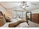 Comfortable primary bedroom with plush bedding, bay window, and elegant furniture at 14417 W 57Th Pl, Arvada, CO 80002
