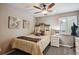 Inviting bedroom with soft colors, art, and a cozy bed, complemented by natural light at 14417 W 57Th Pl, Arvada, CO 80002