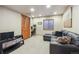 Bonus room with a door to an office area and a lounge space with a sofa, perfect for versatile living at 14417 W 57Th Pl, Arvada, CO 80002
