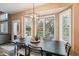 Dining room with large windows, plantation shutters, stylish chandelier and dark wood table at 14417 W 57Th Pl, Arvada, CO 80002