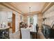 Elegant dining room with a large table, stylish lighting, and access to the kitchen at 14417 W 57Th Pl, Arvada, CO 80002