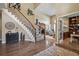 Inviting foyer featuring hardwood floors, a staircase with iron railings, and high ceilings at 14417 W 57Th Pl, Arvada, CO 80002