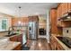 A spacious kitchen with stainless steel appliances, granite countertops, and hardwood floors at 14417 W 57Th Pl, Arvada, CO 80002