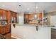 Kitchen featuring granite countertops, stainless steel appliances, wooden cabinetry, and tile backsplash at 14417 W 57Th Pl, Arvada, CO 80002