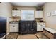 Bright laundry room featuring modern appliances, ample cabinet storage, and a convenient folding area at 14417 W 57Th Pl, Arvada, CO 80002