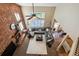 Spacious living room boasts a brick fireplace and ample seating, creating a cozy and inviting atmosphere at 14417 W 57Th Pl, Arvada, CO 80002