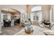 Bright living room with a large window, comfortable seating, and an adjacent dining area at 14417 W 57Th Pl, Arvada, CO 80002