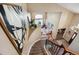 View from the stair landing into the living room with natural lighting and inviting living space at 14417 W 57Th Pl, Arvada, CO 80002
