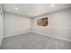 Basement interior with a large window and light neutral colored walls and carpet at 17548 E Wesley Pl, Aurora, CO 80013