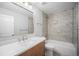 Modern bathroom featuring a sleek vanity and updated shower-tub combo at 17548 E Wesley Pl, Aurora, CO 80013