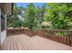 Wooden deck with stairs and wood railing overlooking a green backyard with large trees at 17548 E Wesley Pl, Aurora, CO 80013
