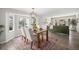 Bright dining area with a modern table set, complementary rug, and views to the living room at 17548 E Wesley Pl, Aurora, CO 80013