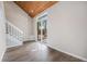 Empty room features hardwood floors, a vaulted wood ceiling and a glass sliding door to a patio at 17548 E Wesley Pl, Aurora, CO 80013